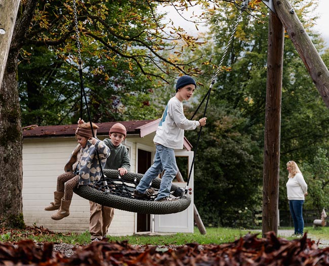 Kinder auf einer Nestschaukel